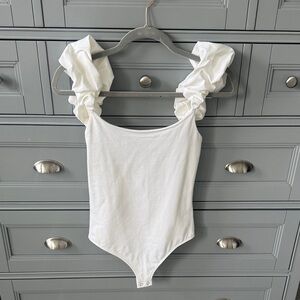 Express White Ruffled-Shoulder One-Piece Bodysuit. Brand new never worn.